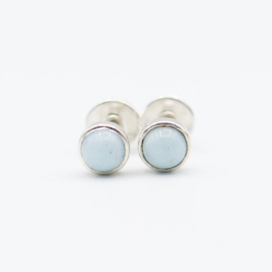 Small round cabochon studs in sterling silver and glass, featuring a tiny upcycled round glass