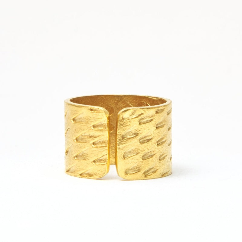 Adjustable, textured wide band brass ring with 18k gold plating, evoking an ethnic vibe inspired by Bronze Age jewelry.