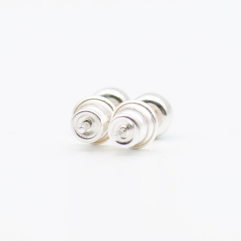 Small round cabochon studs in sterling silver and glass, featuring a tiny upcycled round glass. 