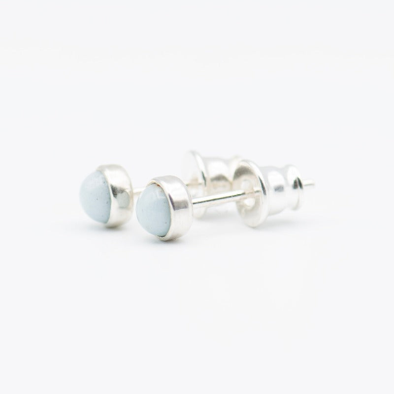 Small round cabochon studs in sterling silver and glass, featuring a tiny upcycled round glass
