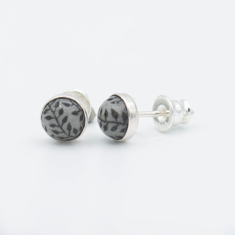 Medium round cabochon studs in sterling silver and glass, featuring a delicate painting of a climbing plant.