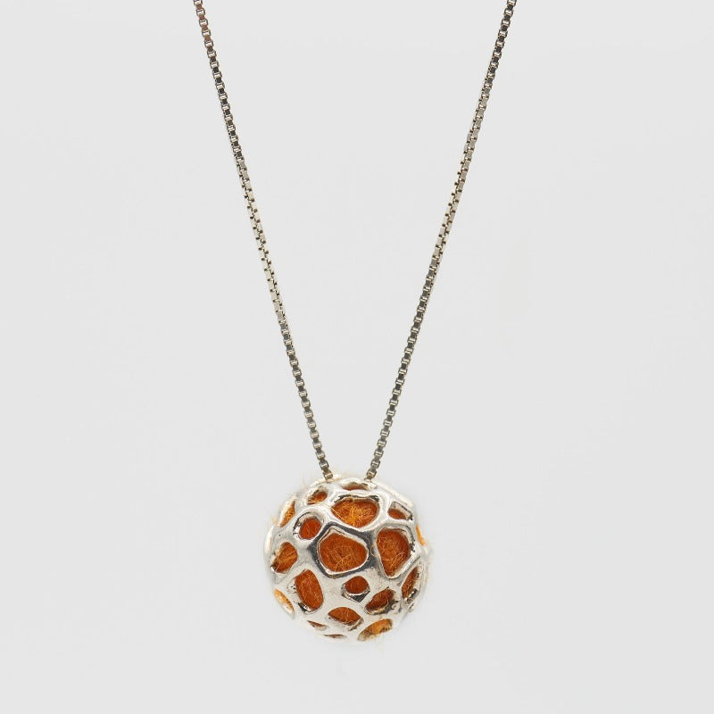 Sterling silver pendant featuring a simple hollow organic shape with colored wool inside, visible through the outer layer. The sphere measures approximately 1.5 cm, paired with a 60 cm sterling silver chain. Orange wool