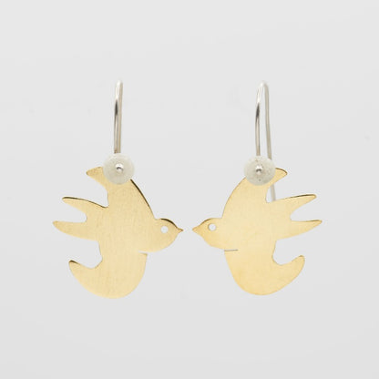 Swallow earrings made from recycled glass, recycled brass and recycled sterling silver. Hand-cut stylised swallow in 18k gold-plated brass, with small handmade glass bead hanging from a sterling silver hook.